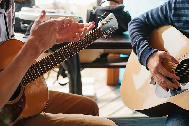 A man having a guitar tutor lesson